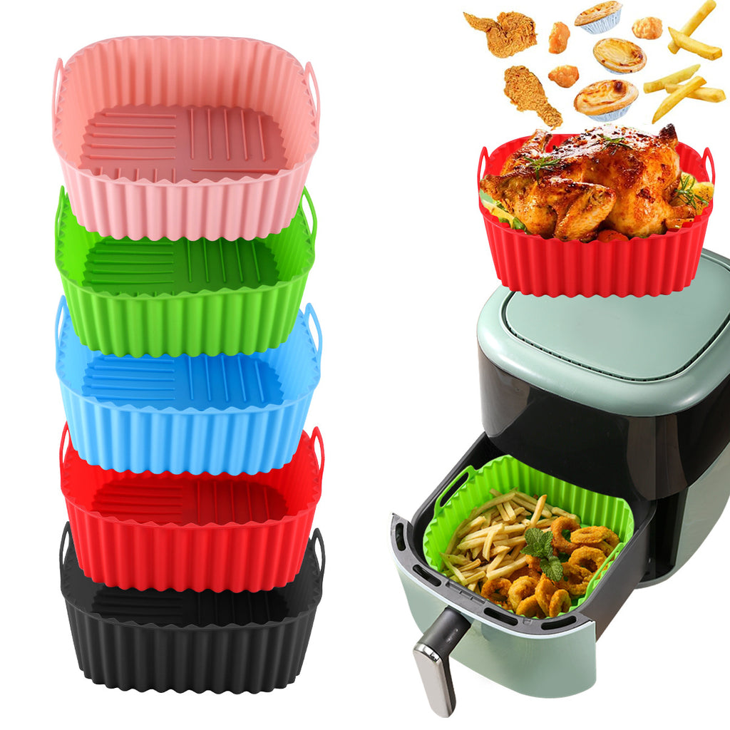A piles of air fryer trays in different colors