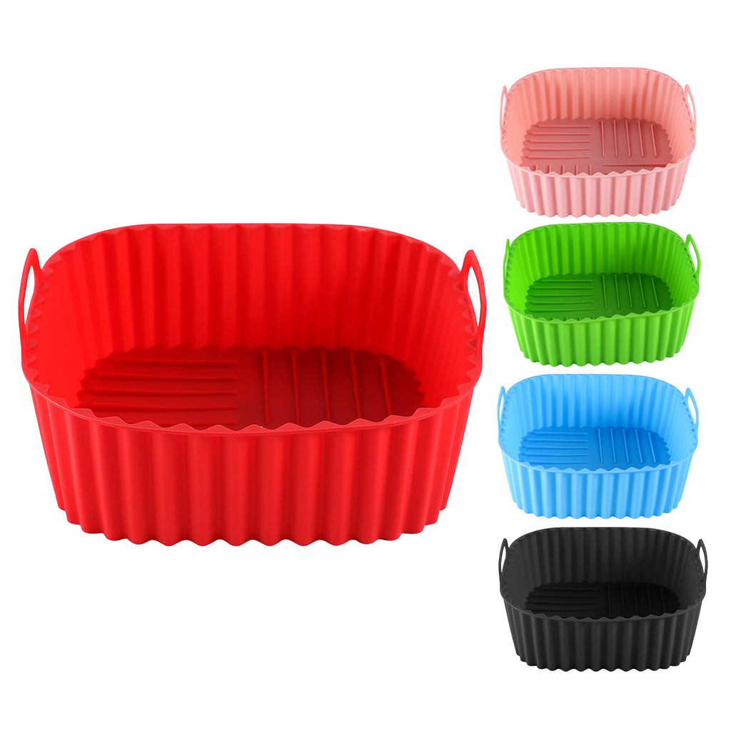 Five air fryer trays in different colors.