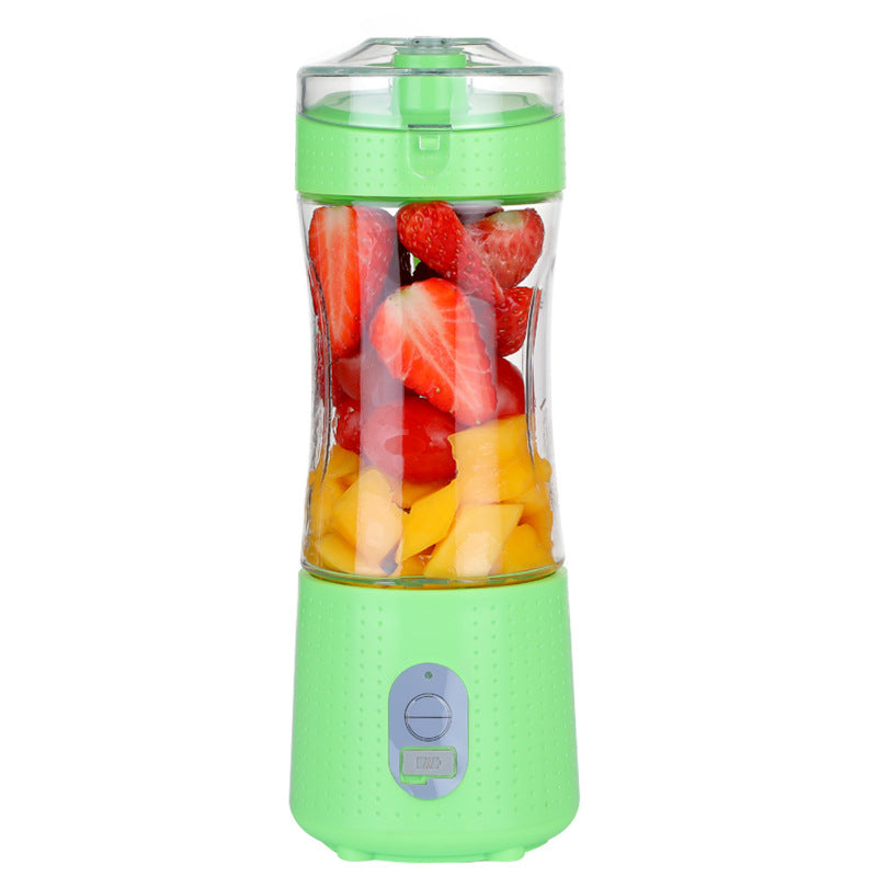 Green portable blender with fruits.