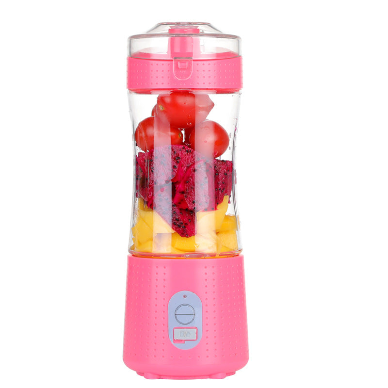 Pink portable blender full of cut fruits.